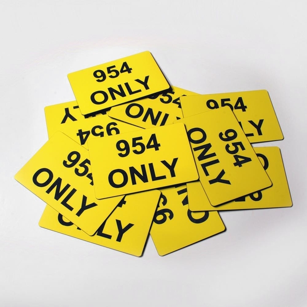 Pile of yellow/black custom placards with the words, "954 ONLY"