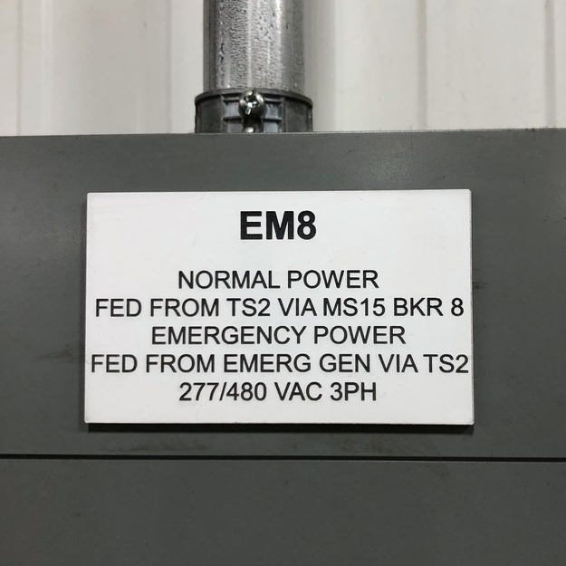 White/black placard reading, "EM8", followed by information