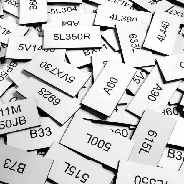 Pile of small white/black placards with text